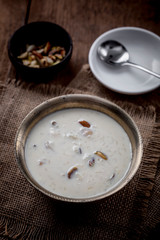 Kheer or Payasam is a type of rice pudding from the Indian subcontinent, made by boiling milk and sugar and is flavoured with dry fruits and nuts, served in metal bowl.