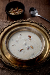 Kheer or Payasam is a type of rice pudding from the Indian subcontinent, made by boiling milk and sugar and is flavoured with dry fruits and nuts, served in metal bowl.
