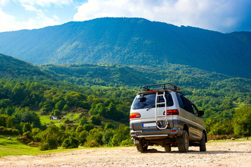 A car on the slope of a mountain. Traveling by car in the mountains.