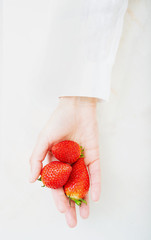 Fresh strawberries in female hand