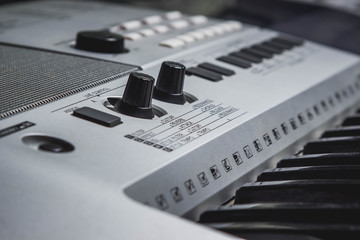 synthesizer close-up. Keys and settings buttons. Blurred background