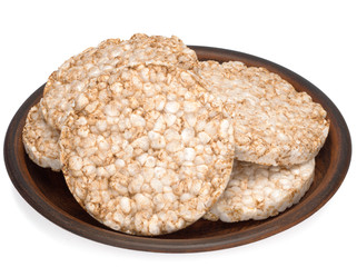 Puffed rice bread in a plate isolated on white background, diet crispy round multigrain rice waffles