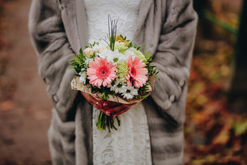 Wedding bouquet, a bouquet of flowers in the hands of the bride close-up