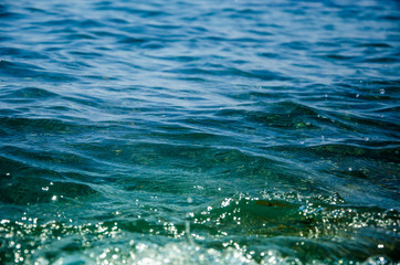 Obraz premium Sea abstract background sunlight glittering on surface of dark water