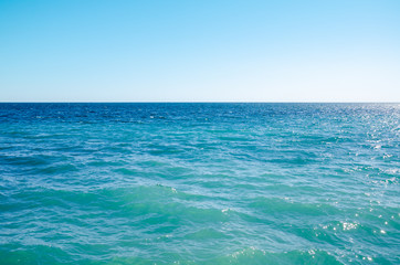 Fototapeta na wymiar Seascape background vivid blue sea and clear sky