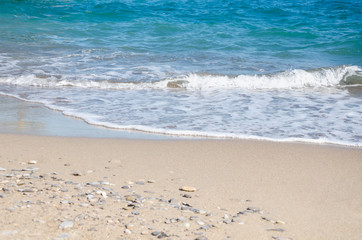 Seascape background white sea waves on golden sandy beach