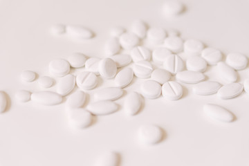 Fototapeta na wymiar Pile of white pills on white background.