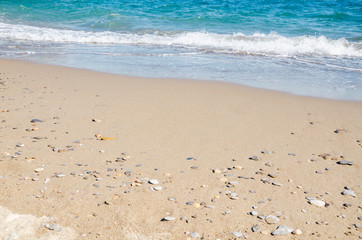 Fototapeta na wymiar Seascape background white sea waves on golden sandy beach