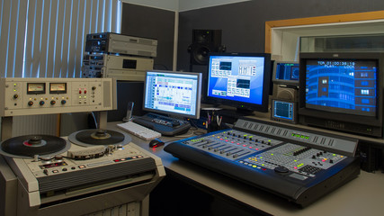 Professional analog tape recorde in TV production studio interior.