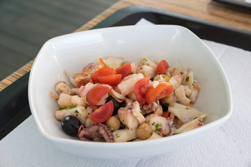 Fish salad with tomatoes and olives