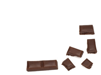 close up of dark porous chocolate pieces on white background