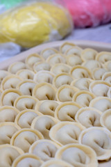 pelmeni or dumplings with colorful dough. Vertical