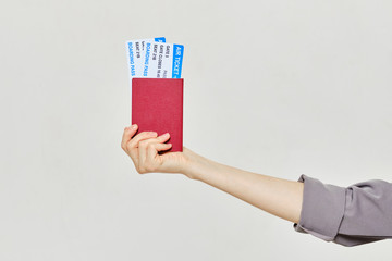 Hand with tickets and passport.