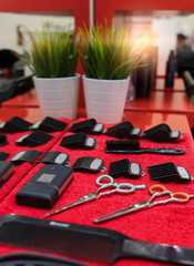 Hairdresser tools flat lay on red towel