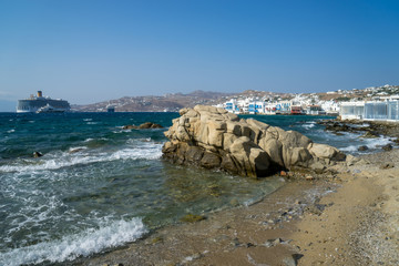 Nice view of the  Greek island of Mykonos - big white ship and old town on the background of the...