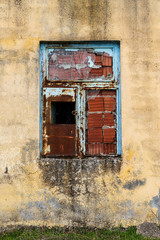 Old brick wall painted. Window patched with red brick