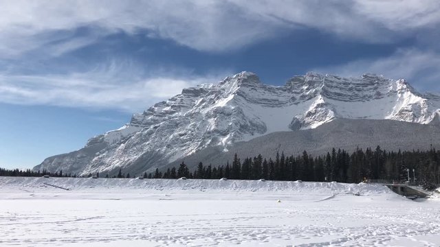 Snow-covered mountains during the winter in Banff. Minnewanka Lake, Alberta, Canada.