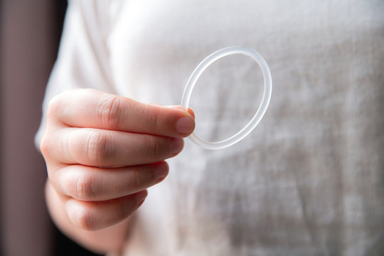 Woman's hand holding a birth control ring, vaginal ring for contraceptive