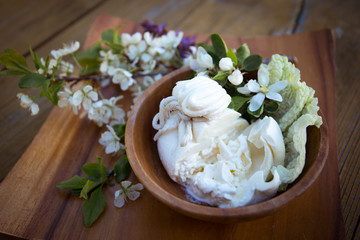 burrata cheese with mozzarella served with flowers on a wooden plate
