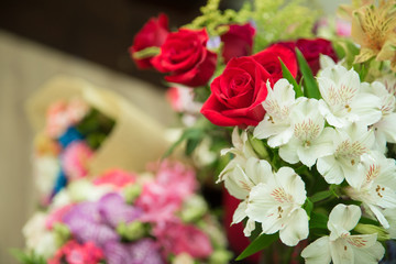 Valentines Day background, wedding day. Blooming red roses flower over blured hexagon bokeh background.