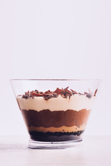 Family Pot of Irresistible Layered Billionaires Dessert made from mousse, Belgian chocolate sauce, digestive biscuit crumb and chocolate sponge. Finished with choco chunks and decorated with icing