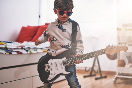 boy play electric guitar and learns  