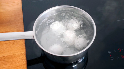 Chicken Eggs are cooked in a pan on electric stave.