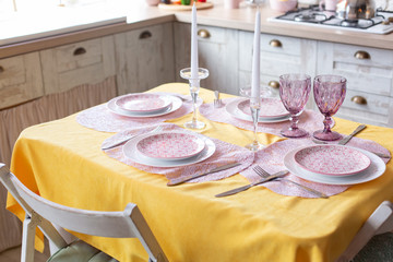 kitchen interior. festive table with yellow tablecloth