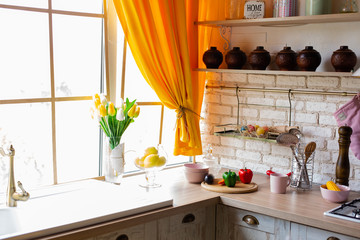 bright kitchen interior. yellow tulips on the kitchen window
