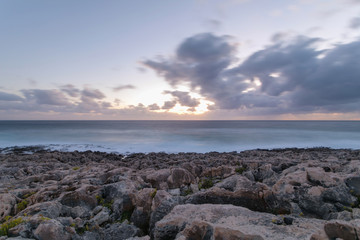 Fototapeta na wymiar Sunset on a rocky beach