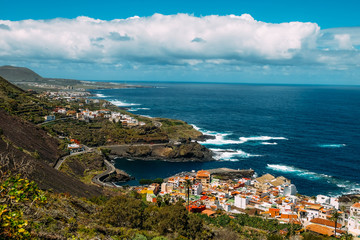 Fototapeta na wymiar Panorama of the city of Garachico from above on the background of the ocean. The island of Tenerife in the spring on a Sunny day. A town on a tropical island in Spain