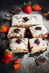 Selective focus. Strawberry chocolate cake on a dark background with fresh strawberries