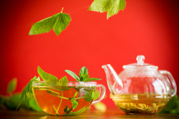 summer refreshing organic tea from currant leaves in a glass teapot