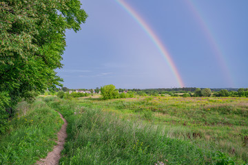 Countryside after storm. Rainbow.
