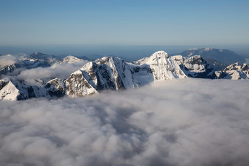 Obraz premium Aerial View of Remote Canadian Mountain Landscape during sunny sunrise. Located near Vancouver, British Columbia, Canada. Nature Background. Authentic