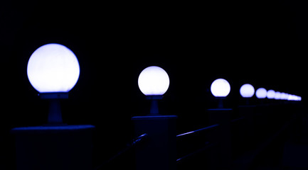 Lamps along a walkway in dark night