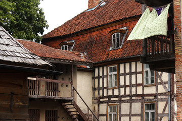 backyard of an old farm studwork frame house and laundry in the wind in the Baltics