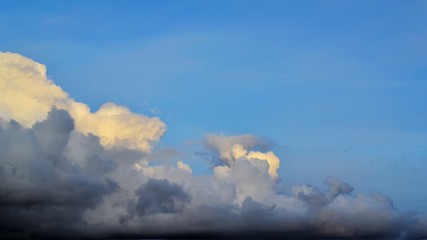 Big cumulus clouds and clouds against the blue sky. Place for text.