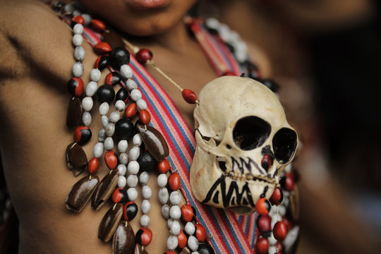 Close shot of an Indian boy's chest with monkey skull