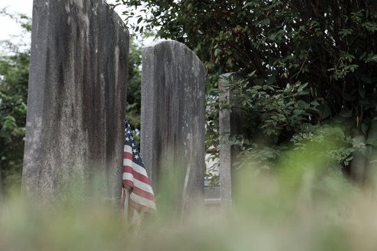 American flag flys over graves of Revolutionary War soldiers