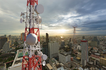 Telecommunication tower with 5G cellular network antenna on city background
