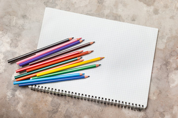 Set of colorful pencil color on grid lines paper, suitable for background and texture isolated on white background. Close up. . Art education concept.