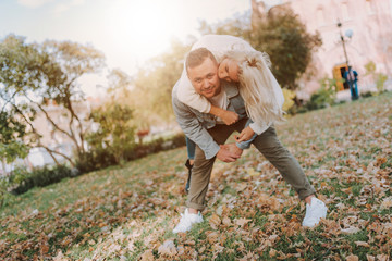 Fototapeta premium Happy young man and woman having fun in autumn park