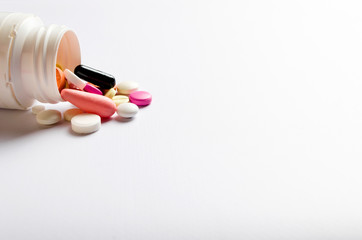 White medicine box and colorful pillson white background. Blur background.