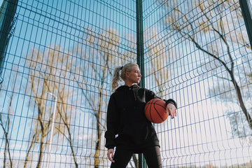 Portrait of active young lady posing outdoors