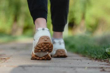 Sport concept. Close-up of legs of a woman running on a track