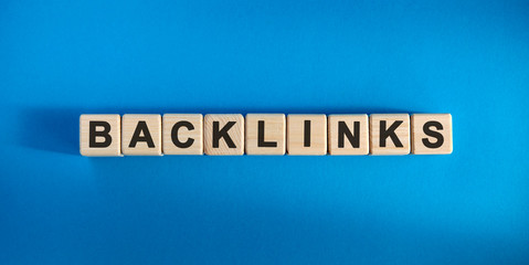 Backlinks - conceptual text with wooden cubes on a dark blue background
