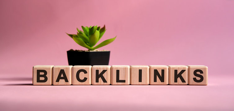 Back link donor - business concept on a pink background. Wooden cubes and flower