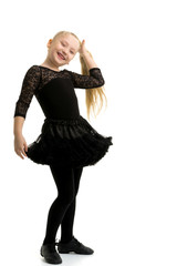 Fototapeta premium A little girl fixes her hair.The concept of style and fashion.