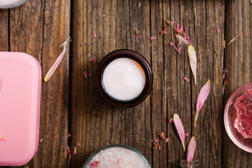 hygiene, beauty products, pink soap, cream, bath salt, tincture, old wooden table background